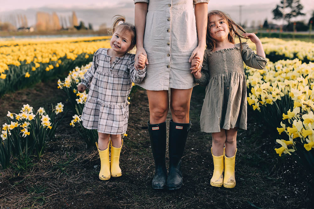 Family in a field of daffodils at Tulip Valley Farms